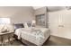 Neutral-toned bedroom featuring a large bed, end table with lamp and blind covered window at 7428 N Via Camello Del Norte -- # 182, Scottsdale, AZ 85258