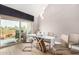 Dining area with glass table set for four and sliding glass doors leading to outdoor balcony at 7428 N Via Camello Del Norte -- # 182, Scottsdale, AZ 85258