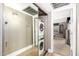 Hallway with stacked washer and dryer featuring mirrored closet doors and carpeted floors at 7428 N Via Camello Del Norte -- # 182, Scottsdale, AZ 85258