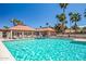 Large swimming pool surrounded by lounge chairs and community buildings on a clear day at 7428 N Via Camello Del Norte -- # 182, Scottsdale, AZ 85258