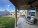 View of the covered back patio with rocking chairs overlooking the lush backyard at 853 E Ross Ave, Phoenix, AZ 85024