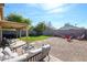 Relaxing backyard patio with a covered area, lush lawn, and a charming seating area at 853 E Ross Ave, Phoenix, AZ 85024