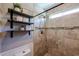 Updated bathroom showcasing decorative shelves and tiled shower with a built-in niche at 853 E Ross Ave, Phoenix, AZ 85024