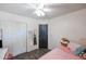 Bright bedroom featuring a closet and a bed with a pink quilt at 853 E Ross Ave, Phoenix, AZ 85024