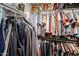 Organized walk-in closet with ample hanging space for suits, shirts, and dresses at 853 E Ross Ave, Phoenix, AZ 85024