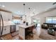 Modern kitchen with stainless steel appliances, a center island, a connected dining area, and tile floors at 853 E Ross Ave, Phoenix, AZ 85024