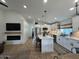 Sunlit kitchen with stainless appliances, island seating, and modern accents open to adjacent entertaining spaces at 853 E Ross Ave, Phoenix, AZ 85024