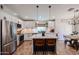 Modern kitchen with stainless steel appliances, a center island, white cabinets, and tile floors at 853 E Ross Ave, Phoenix, AZ 85024