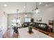 Open-concept living room with breakfast nook, leather couch, and quartz kitchen island at 853 E Ross Ave, Phoenix, AZ 85024