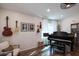 Bright living room features wood floors, ample lighting, a piano, guitars hanging on the wall, and seating at 853 E Ross Ave, Phoenix, AZ 85024