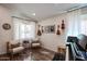 Bright living room features wood floors, ample lighting, a piano, guitars hanging on the wall, and seating at 853 E Ross Ave, Phoenix, AZ 85024