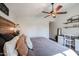 Comfortable main bedroom featuring ceiling fan, decorative wood headboard and in-room desk at 853 E Ross Ave, Phoenix, AZ 85024