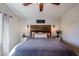 Cozy main bedroom with decorative wood headboard, sconce lighting and soft, neutral bedding at 853 E Ross Ave, Phoenix, AZ 85024