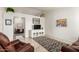 Bright living room featuring tile flooring, a vaulted ceiling, a media center, and a view into the dining area at 870 S Palm Ln # 55, Chandler, AZ 85225