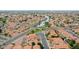 Community aerial view featuring a lake, mature trees and red tile roofs at 909 W San Mateo Ct, Gilbert, AZ 85233