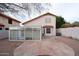 A spacious backyard featuring a unique sunroom and tiled patio, perfect for outdoor entertaining at 909 W San Mateo Ct, Gilbert, AZ 85233