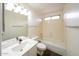 Well-lit bathroom with a pristine white vanity, toilet, and bathtub, and a coordinated mirror and lighting fixture at 909 W San Mateo Ct, Gilbert, AZ 85233