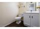 Cozy bathroom featuring a toilet, vanity with black hardware, and an overhead mirror and lighting at 909 W San Mateo Ct, Gilbert, AZ 85233