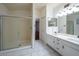 Spacious bathroom featuring shower with glass doors and a double sink vanity at 909 W San Mateo Ct, Gilbert, AZ 85233