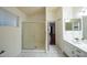 Bright bathroom featuring a large shower with glass doors and a dual sink vanity at 909 W San Mateo Ct, Gilbert, AZ 85233