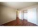 Cozy bedroom featuring wood laminate flooring, a closet, and neutral wall colors at 909 W San Mateo Ct, Gilbert, AZ 85233