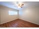 Bedroom featuring wood laminate flooring, neutral walls, ceiling fan, and ample natural light at 909 W San Mateo Ct, Gilbert, AZ 85233