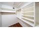 Walk-in closet featuring custom shelving and rack for extra storage at 909 W San Mateo Ct, Gilbert, AZ 85233