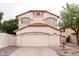 Beige two-story home featuring a red tile roof, concrete driveway, and an attached two-car garage at 909 W San Mateo Ct, Gilbert, AZ 85233