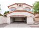 Beige two-story home showcasing garage with red tile roof and concrete driveway for a traditional aesthetic at 909 W San Mateo Ct, Gilbert, AZ 85233