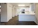 Spacious kitchen featuring white cabinetry and a convenient breakfast bar with open floor plan at 909 W San Mateo Ct, Gilbert, AZ 85233