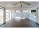 Enclosed sunroom with tiled flooring, abundant windows, and a ceiling fan for year-round comfort at 909 W San Mateo Ct, Gilbert, AZ 85233