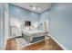 Cozy bedroom with light blue walls, wood floors, and soft, natural lighting at 9160 E Wethersfield Rd, Scottsdale, AZ 85260