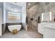 Modern main bathroom with a standalone tub, decorative tile, and separate shower at 9160 E Wethersfield Rd, Scottsdale, AZ 85260