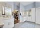 Elegant main bathroom boasts dual vanities, a walk-in closet, and calming blue accents at 9160 E Wethersfield Rd, Scottsdale, AZ 85260