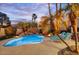 Beautiful pool area with vibrant palm trees and a tranquil rock waterfall feature at 9160 E Wethersfield Rd, Scottsdale, AZ 85260