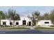 Contemporary home exterior featuring a flat roof, white stucco, dark framed windows and desert landscaping at 9611 E Clinton St, Scottsdale, AZ 85260