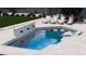 Backyard pool with water feature, in-pool seating, and patio with lounge chairs at 9611 E Clinton St, Scottsdale, AZ 85260