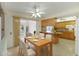 Inviting kitchen and dining area with wood cabinets, granite countertops, and bright lighting at 10001 W Deanita Ln, Sun City, AZ 85351