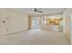 An open living space leads to the kitchen and a patio with a ceiling fan at 10001 W Deanita Ln, Sun City, AZ 85351