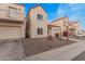 Two-story townhome featuring a front-facing garage, driveway, and low-maintenance landscaping at 1018 W Libra Dr, Tempe, AZ 85283