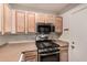 Galley kitchen with stainless steel microwave and gas stove at 1018 W Libra Dr, Tempe, AZ 85283