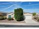 Charming single-story home with a two car garage, desert landscaping, and a well maintained front yard at 10508 W Odeum Ln, Tolleson, AZ 85353