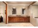 Elegant bathroom features a double vanity with a marble countertop and warm wood cabinetry at 10597 E Rising Sun Dr, Scottsdale, AZ 85262