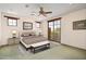 Bright bedroom features a ceiling fan, neutral colors, and a private balcony entrance at 10597 E Rising Sun Dr, Scottsdale, AZ 85262