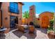 Inviting courtyard featuring a fireplace, seating, and lush greenery for outdoor living at 10597 E Rising Sun Dr, Scottsdale, AZ 85262