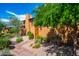 Beautiful home with desert landscaping and a custom wooden door under a bright blue sky at 10597 E Rising Sun Dr, Scottsdale, AZ 85262