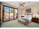 Serene bedroom with sliding glass doors leading to a private outdoor space and natural light at 10597 E Rising Sun Dr, Scottsdale, AZ 85262