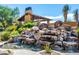 Spectacular backyard water feature with rock waterfall cascading into a serene pool, perfect for relaxation at 10597 E Rising Sun Dr, Scottsdale, AZ 85262