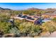 A gorgeous aerial view of a home fitted with solar panels in a beautiful desert setting at 11415 E Four Peaks Rd, Scottsdale, AZ 85262