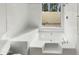 All-white bathroom with a soaking tub, shower, and a window for natural light and privacy at 11609 N 30Th Ln, Phoenix, AZ 85029